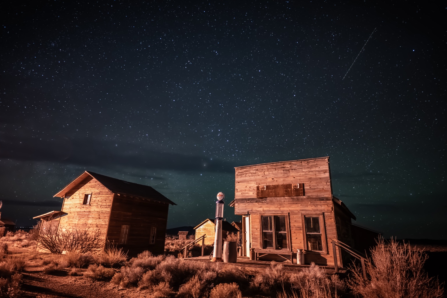 An old wooden building under a field of stars
